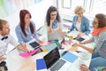 High angle view of businesspeople analyzing photographs in creative office