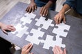 High Angle View Of Businesspeople Solving Jigsaw Puzzle Royalty Free Stock Photo