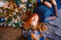 High angle view of caucasian beautiful woman lying on floor near christmas tree Royalty Free Stock Photo
