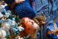 High angle view of caucasian beautiful woman lying on floor near christmas tree Royalty Free Stock Photo