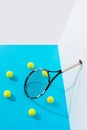 high angle view circle of tennis balls around tennis racket on blue