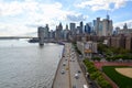 High-angle view of a city with skyscrapers and a bridge with moving cars