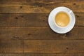 High angle view of coffee in white cup with saucer on old wooden background, close up Royalty Free Stock Photo
