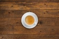 High angle view of coffee in white cup with saucer on old wooden background, close up Royalty Free Stock Photo
