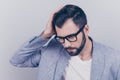 High angle view of confident handsome brunet in smart casual, glasses, standing on the pure background, fixing his perfect Royalty Free Stock Photo