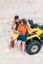 high angle view of confused young couple with ATV trying to navigate with digital tablet