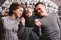 High angle view of a couple of attractive young parents lying in a bed with their cute baby girl. happy holiday Royalty Free Stock Photo