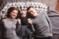 High angle view of a couple of attractive young parents lying in a bed with their cute baby girl. happy holiday Royalty Free Stock Photo