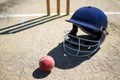 High angle view of cricket ball with helmet on pitch Royalty Free Stock Photo