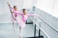 high angle view of cute little ballet dancers stretching Royalty Free Stock Photo