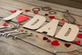 High angle view of dad text with heart shapes and work tools Royalty Free Stock Photo