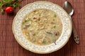 High angle view of delicious homemade chicken soup with traditional bulgarian liaison, noodles, parsley, bay leaf and grated carro Royalty Free Stock Photo