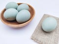 High angle view of duck eggs in a plate on a white background.