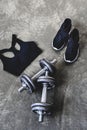 high angle view of dumbbells with sneakers and sport bra