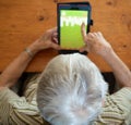 High Angle View of an Elderly Woman Playing Solitaire on a Table Royalty Free Stock Photo