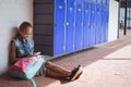 High angle view of elementary student using mobile phone by lockers Royalty Free Stock Photo
