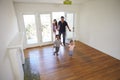 High Angle View Of Family Exploring New Home On Moving Day