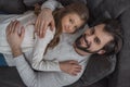 high angle view of father and daughter hugging on sofa and looking Royalty Free Stock Photo