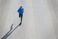 High angle view of female runner jogging on road city. Royalty Free Stock Photo