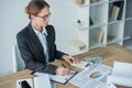 high angle view of financier working at table in office with calculator