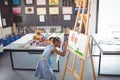 High angle view of focused girl painting on canvas Royalty Free Stock Photo