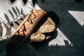 French fresh bread baguette with slices on a ceramic plate on gray background. Royalty Free Stock Photo