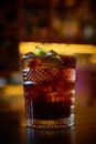 High angle view of a glass of Cuba Libre cocktail with rum, coke, lemon juice and ice cubes