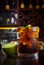 High angle view of a glass of Cuba Libre cocktail with rum, coke, lemon juice and ice cubes