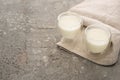 High angle view of glasses of homemade yogurt on beige cloth