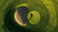 High Angle View of Golfer Putting on Green with Sand Trap Royalty Free Stock Photo