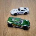 High-angle view of the green and white Mattel Hot Wheels toy cars made of metal on a wooden surface Royalty Free Stock Photo