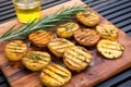 high angle view of grilled potatotes and rosemary on a board