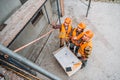 high angle view of group of builders discussing building plan at construction site