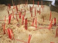 Group of Red Used Incense Stick Leftovers at Buddhist Temple with Selective Focus