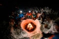 high angle view of group of tourists sitting around a campfire in winter evening. Royalty Free Stock Photo