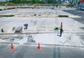 Group of Unrecognizable Construction Workers Working at Parking Lot Royalty Free Stock Photo