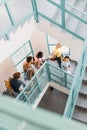 high angle view of group of young students walking down stairs Royalty Free Stock Photo