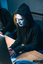 high angle view of hacker in mask working with computer to Royalty Free Stock Photo