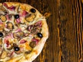 High angle view of half of tasty pizza with ham, mushrooms, olives Royalty Free Stock Photo