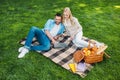 high angle view of happy couple using laptop on plaid at picnic Royalty Free Stock Photo