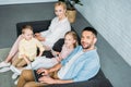 high angle view of happy family using digital devices and smiling Royalty Free Stock Photo