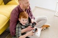 high angle view of happy father and son playing with joysticks Royalty Free Stock Photo