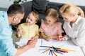 high angle view of happy parents with cute little kids drawing together Royalty Free Stock Photo