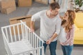 high angle view of happy young pregnant couple smiling each other while standing near baby Royalty Free Stock Photo