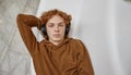 High angle view headshot portrait of young red-haired boy in headphones Royalty Free Stock Photo