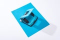 High angle view of holepunch and colorful paper on white background. Royalty Free Stock Photo