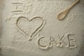 High angle view of i love cake text on flour