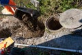 High angle view of laborer, dumping a wheelbarrow of soil.