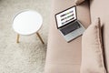 high angle view of laptop standing on cozy couch with youtube website