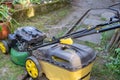 High angle view of lawnmower on stone path. Royalty Free Stock Photo
